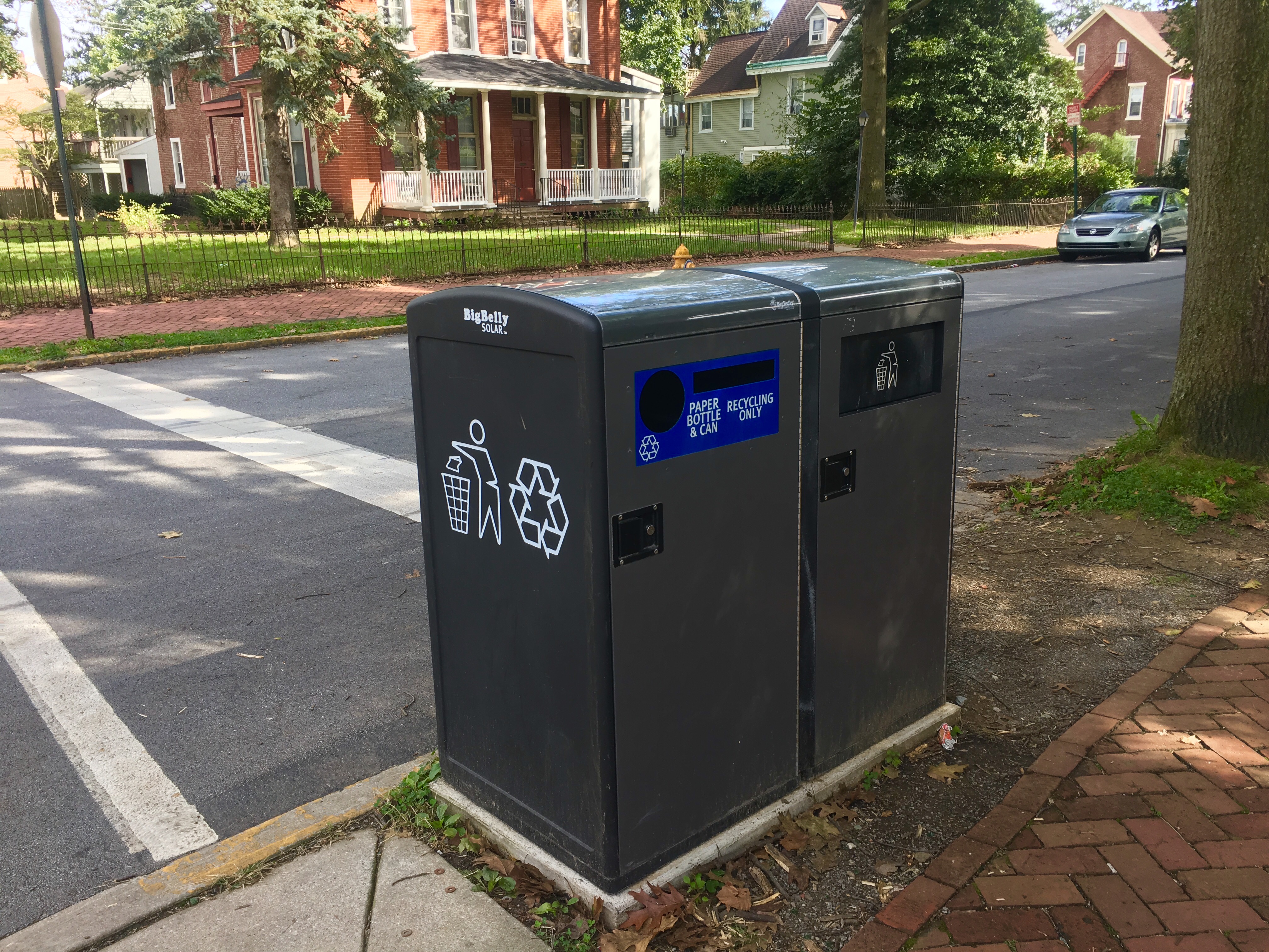 Recycling and Trash containers located off campus on Walnut St 