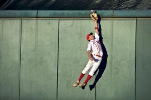 Baseball player catching a ball in outfield