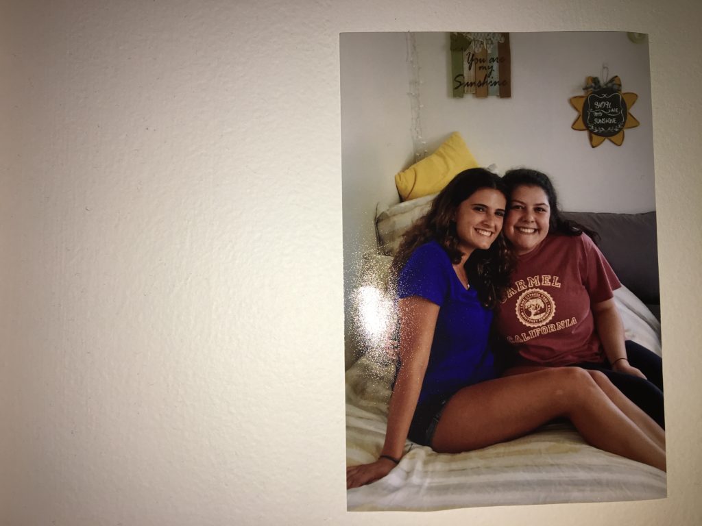 A memorable picture of roommates sitting on a bed final year of college