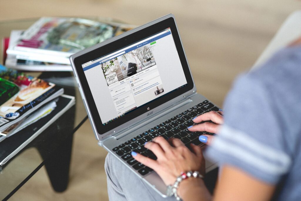 Person using a social media site on a laptop